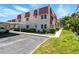 Exterior of building with assigned parking, lush landscaping, and sidewalks at 10035 63Rd N Ave # 12, St Petersburg, FL 33708