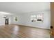 Bright living room featuring wood-look flooring and large windows offering plenty of natural light at 10035 63Rd N Ave # 12, St Petersburg, FL 33708
