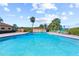 Community pool with clear water and seating around the pool deck, perfect for relaxing and enjoying the sun at 10035 63Rd N Ave # 12, St Petersburg, FL 33708