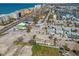 Aerial view of a coastal neighborhood with homes, streets, and the ocean in the background at 103 146Th E Ave, Madeira Beach, FL 33708