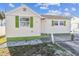 Charming single-story home featuring green shutters, light siding, and a cozy front yard at 103 146Th E Ave, Madeira Beach, FL 33708