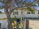 Exterior shot showcasing a charming home with a white picket fence and well-maintained landscaping at 103 146Th E Ave, Madeira Beach, FL 33708