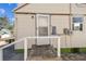Rear exterior entrance featuring a ramp and access door with neutral siding at 103 146Th E Ave, Madeira Beach, FL 33708