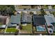 An aerial view of a fenced property highlighting the backyard, neighboring houses, and nearby street at 10906 Kenbrook Dr, Riverview, FL 33578