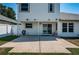 Backyard view of the home featuring a concrete patio and sliding glass doors at 10906 Kenbrook Dr, Riverview, FL 33578