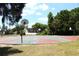 Outdoor basketball court with multiple hoops, surrounded by green spaces and neighborhood homes at 10906 Kenbrook Dr, Riverview, FL 33578