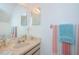 Bright bathroom featuring a neutral-toned vanity and a large mirror with a view at 10906 Kenbrook Dr, Riverview, FL 33578