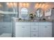 Elegant bathroom featuring double sinks, granite countertops, white cabinets, and a glass-enclosed shower at 10906 Kenbrook Dr, Riverview, FL 33578