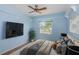 Comfortable bedroom featuring light blue walls, window and stylish decor at 10906 Kenbrook Dr, Riverview, FL 33578