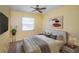 Stylishly furnished bedroom with a ceiling fan, window, and decorative art at 10906 Kenbrook Dr, Riverview, FL 33578