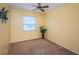 Bright bedroom with a ceiling fan, neutral walls, and a window with natural light at 10906 Kenbrook Dr, Riverview, FL 33578