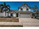Charming two-story home featuring a two-car garage, manicured lawn, and lush landscaping for enhanced curb appeal at 10906 Kenbrook Dr, Riverview, FL 33578