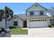 Inviting two-story home with a well-manicured lawn, mailbox, and an attached garage at 10906 Kenbrook Dr, Riverview, FL 33578