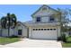 Charming two-story home featuring a spacious garage and well-maintained landscaping at 10906 Kenbrook Dr, Riverview, FL 33578