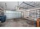 Spacious garage with a garage door, ample shelving, and space for parking vehicles at 10906 Kenbrook Dr, Riverview, FL 33578