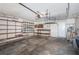 View of garage space with wooden shelving and room for storage at 10906 Kenbrook Dr, Riverview, FL 33578