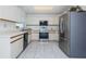 Well-lit kitchen featuring modern stainless steel appliances, white cabinets, and light countertops at 10906 Kenbrook Dr, Riverview, FL 33578