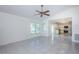 Living room with vaulted ceiling, tile floor, and view to the kitchen at 10906 Kenbrook Dr, Riverview, FL 33578