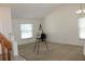 Cozy living room with plush carpeting, natural light, and staircase in the background at 10906 Kenbrook Dr, Riverview, FL 33578