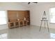 Bright living room with tile flooring, built-in shelving, and plenty of space for entertaining at 10906 Kenbrook Dr, Riverview, FL 33578