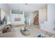 Bright living room featuring neutral tones, a staircase, and ample natural light, creating an inviting atmosphere at 10906 Kenbrook Dr, Riverview, FL 33578