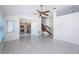 Open-concept living room with tile floors, a staircase, and a view into the kitchen, perfect for entertaining at 10906 Kenbrook Dr, Riverview, FL 33578