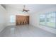 Spacious and bright living room featuring neutral walls and tile flooring, with a large built-in media unit at 10906 Kenbrook Dr, Riverview, FL 33578