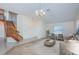 Spacious living room with staircase, neutral color palette, modern furniture, and ample natural light at 10906 Kenbrook Dr, Riverview, FL 33578