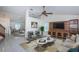 Bright living room with vaulted ceilings, ceiling fan, modern furnishings, and a built-in entertainment center at 10906 Kenbrook Dr, Riverview, FL 33578