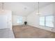 Bright living room featuring neutral carpet, a high vaulted ceiling, and large windows offering plenty of natural light at 10906 Kenbrook Dr, Riverview, FL 33578