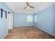 Spacious bedroom with carpet, ceiling fan, and a window overlooking the yard at 10906 Kenbrook Dr, Riverview, FL 33578