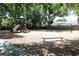 Community playground with slide, climbing structure, swings, and a wood chip ground covering at 10906 Kenbrook Dr, Riverview, FL 33578