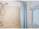 Standard shower featuring tile walls, shower head and clear window at 10906 Kenbrook Dr, Riverview, FL 33578