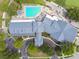 Overhead view showcasing the community pool, golf course, and clubhouse with manicured landscaping and ample parking at 11147 Brambleleaf Way, Hudson, FL 34667