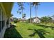 Large backyard with lush lawn, mature trees, and tropical landscaping creates a private oasis at 11147 Brambleleaf Way, Hudson, FL 34667