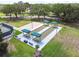 Aerial view featuring community bocce ball courts, meticulously maintained and beautifully landscaped at 11147 Brambleleaf Way, Hudson, FL 34667