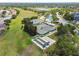 Aerial shot highlighting tennis courts and bocce ball courts within a vibrant community setting at 11147 Brambleleaf Way, Hudson, FL 34667
