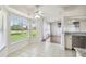 Bright dining area with backyard views, tile floors, ceiling fan, and access to living areas at 11147 Brambleleaf Way, Hudson, FL 34667