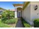 Inviting front entrance featuring a well-manicured landscape and a charming front door at 11147 Brambleleaf Way, Hudson, FL 34667