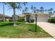 Charming single-story home featuring a well-maintained lawn and a welcoming two-car garage at 11147 Brambleleaf Way, Hudson, FL 34667
