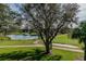 View of the meticulously manicured golf course and a scenic pond in a lush, green setting at 11147 Brambleleaf Way, Hudson, FL 34667