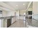 Kitchen with stainless steel appliances, granite countertops, and ample storage space at 11147 Brambleleaf Way, Hudson, FL 34667