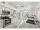 Well-lit kitchen features granite countertops, stainless steel appliances, and a view of the outdoor scenery at 11147 Brambleleaf Way, Hudson, FL 34667