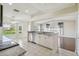 Open kitchen showcases granite countertops, stainless steel appliances, and views of the living and dining areas at 11147 Brambleleaf Way, Hudson, FL 34667