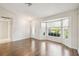 Bright living room featuring beautiful hardwood floors, a bay window and plenty of natural light at 11147 Brambleleaf Way, Hudson, FL 34667