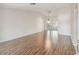 Spacious living room featuring hardwood floors and an abundance of natural light at 11147 Brambleleaf Way, Hudson, FL 34667