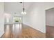 Bright living room featuring wood floors, a large window, and elegant chandelier at 11147 Brambleleaf Way, Hudson, FL 34667