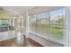 Enclosed patio area with tiled flooring, expansive windows with view of backyard at 11147 Brambleleaf Way, Hudson, FL 34667