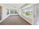 Bright sunroom with large windows, allowing for natural light and peaceful enjoyment of the outdoors at 11147 Brambleleaf Way, Hudson, FL 34667
