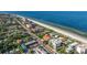 Aerial view showcases beachfront property on the beach with nearby community and homes at 1206 Gulf Blvd # C, Indian Rocks Beach, FL 33785